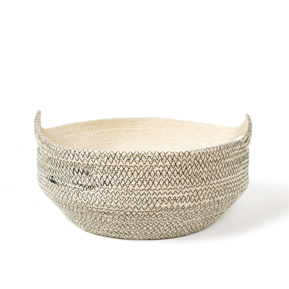 
                      
                        Woven basket with a zigzag stitching pattern on a white background
                      
                    
