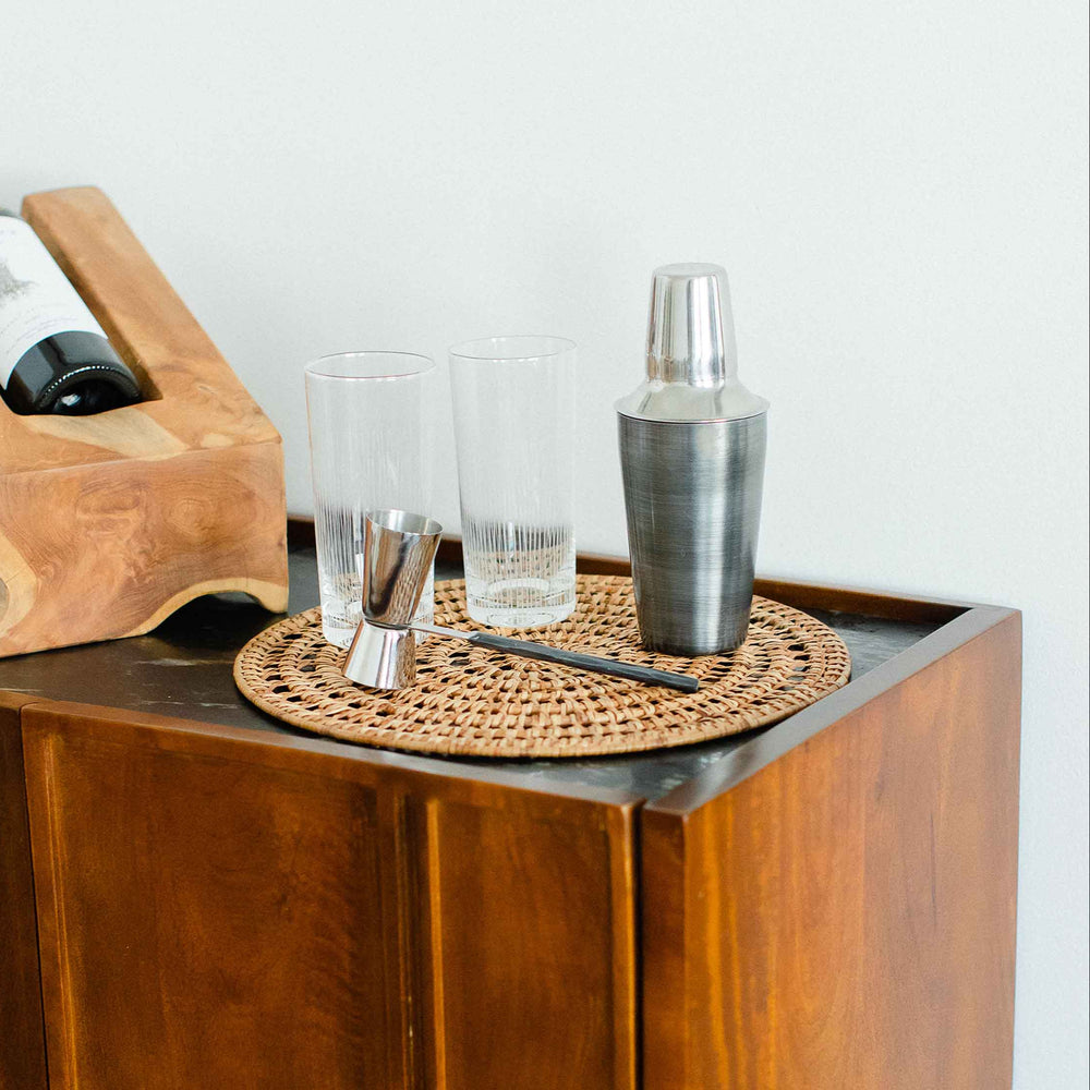 
                      
                        Wooden bar cart with bottles, glasses, and a cocktail shaker on a white background
                      
                    