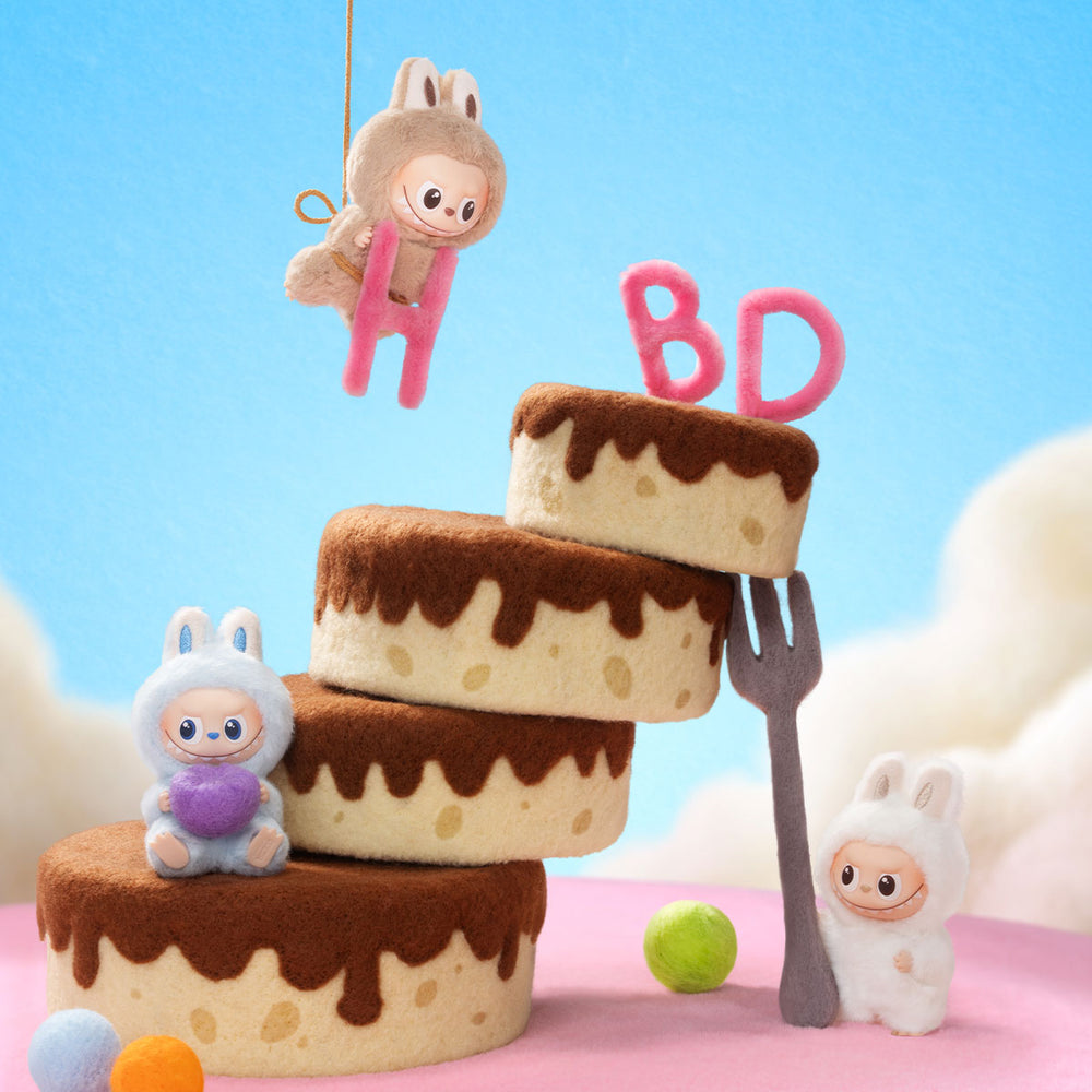 
                      
                        Stack of felt birthday cakes with cute mini Labubu dolls and 'BD' letters on a blue background
                      
                    