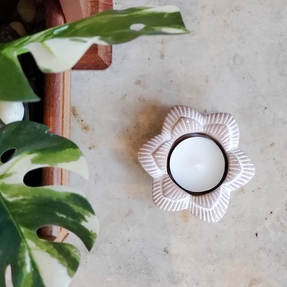 Aerial view of terracotta tealight candle holder in the shape of a flower.