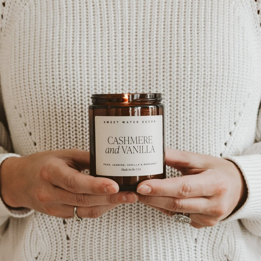 
                      
                        Sweet Water Decor Cashmere and Vanilla Soy Candle - Amber Jar - 9 oz - lily & onyx
                      
                    