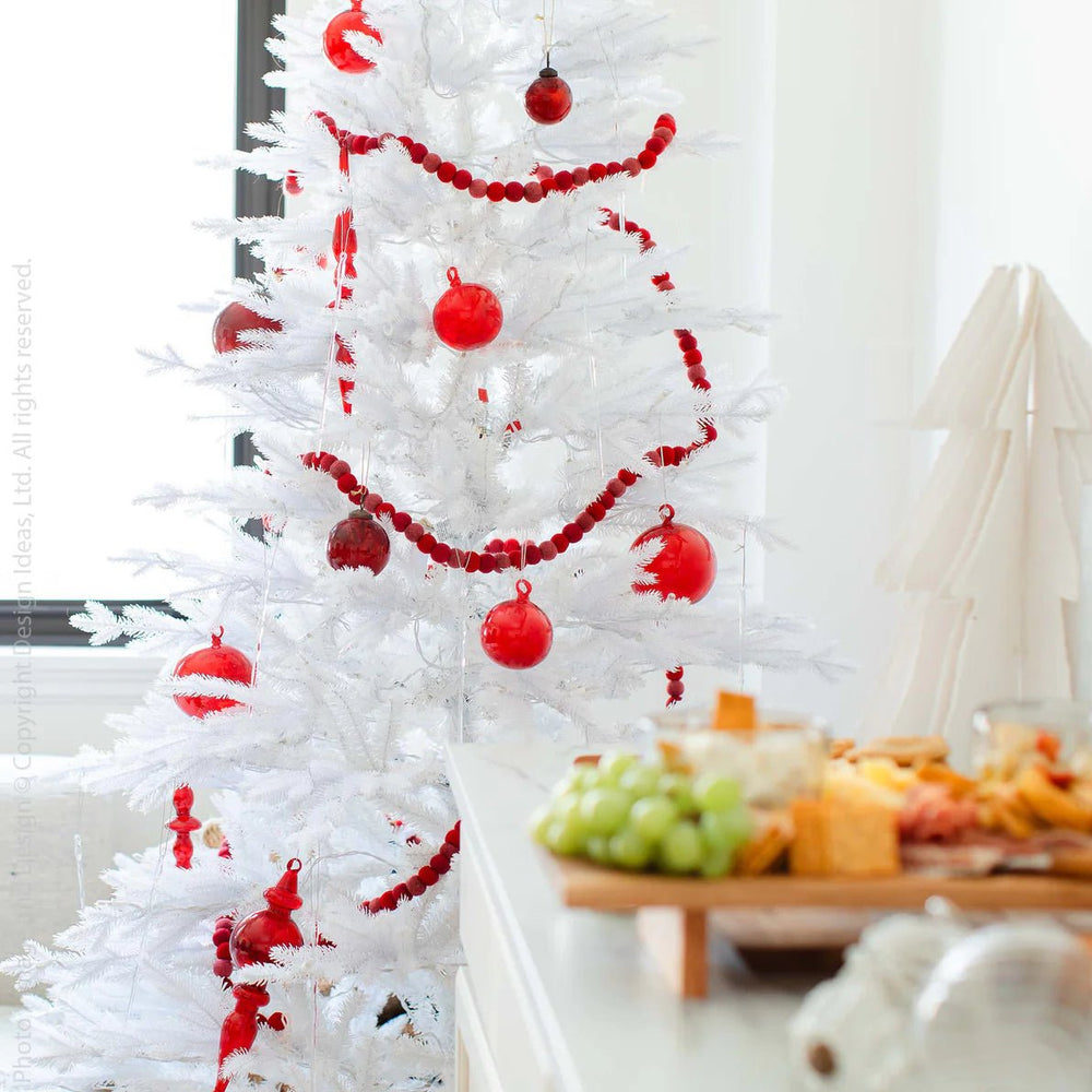 
                      
                        Moroah™ Mouth Blown Red Glass Ornaments on white Christmas tree next to holiday charcuterie spread.
                      
                    