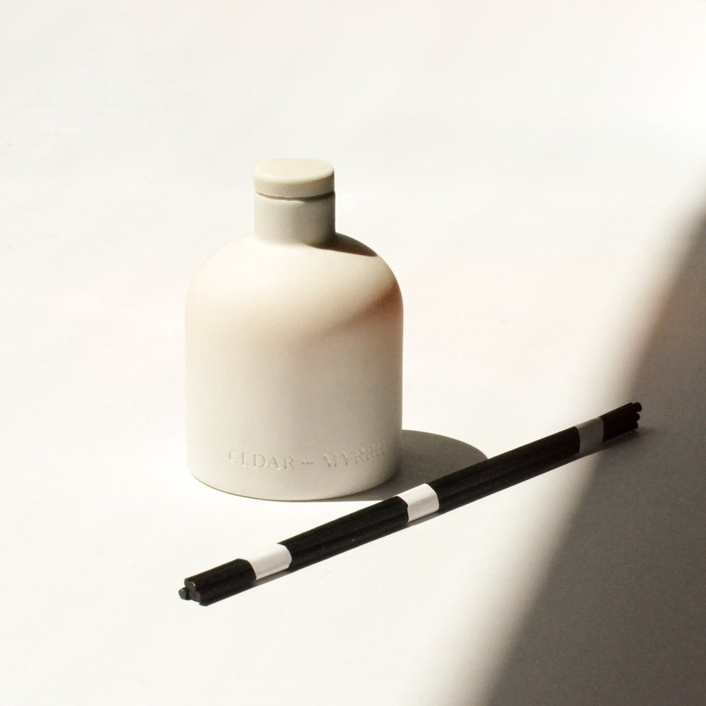 
                      
                        CEDAR AND MYRRH Palo Santo White Ceramic Reed Diffuser - lily & onyx
                      
                    