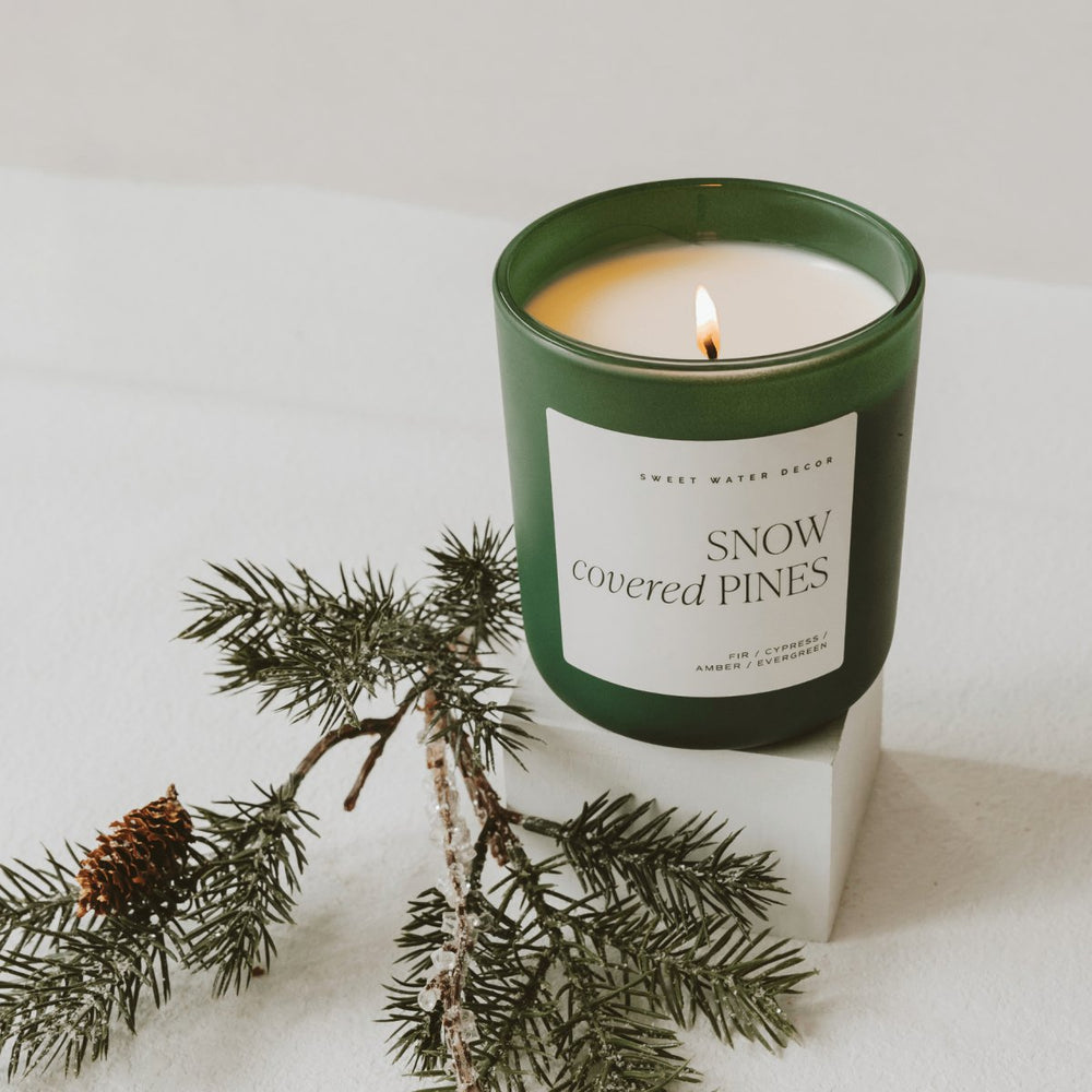 
                      
                        Sweet Water Decor Snow Covered Pines Soy Candle - Green Matte Jar - 15 oz - lily & onyx
                      
                    