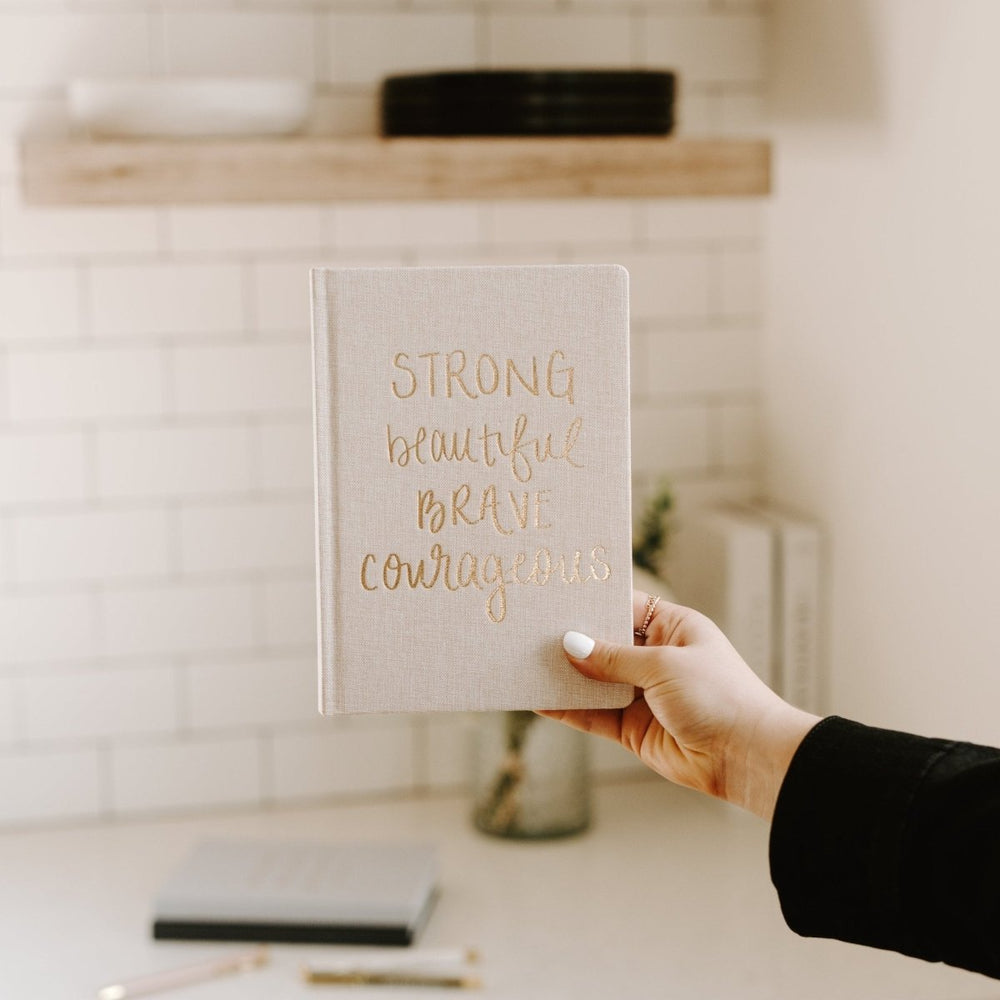 
                      
                        Sweet Water Decor Strong Beautiful Brave Courageous Fabric Journal - lily & onyx
                      
                    