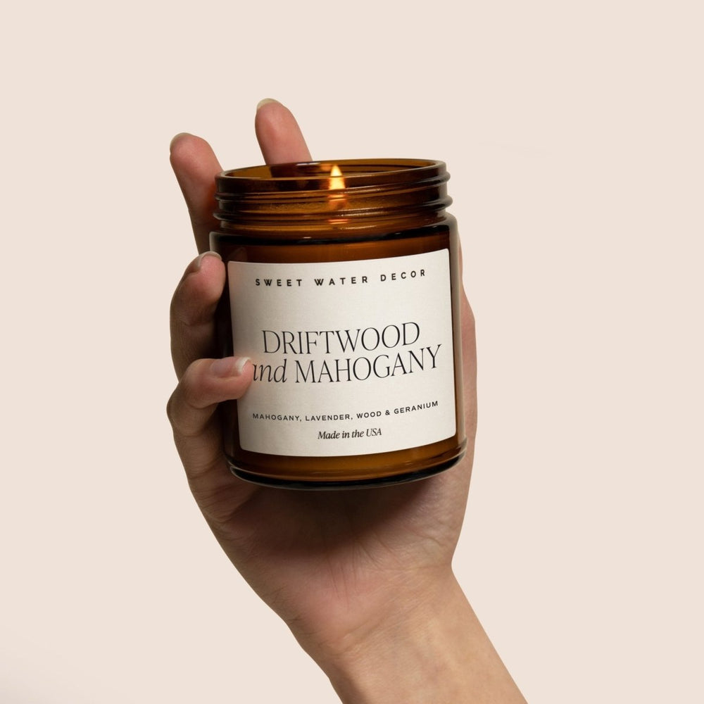 
                      
                        Sweet Water Decor Teakwood and Mahogany Soy Candle - Amber Jar - 9 oz - lily & onyx
                      
                    