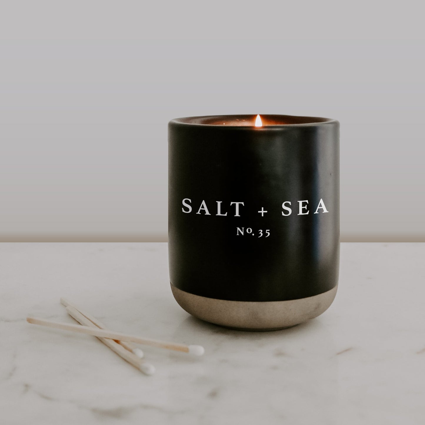 Load image into Gallery viewer, Salt and Sea Soy Candle - Black Stoneware Jar - 12 oz
