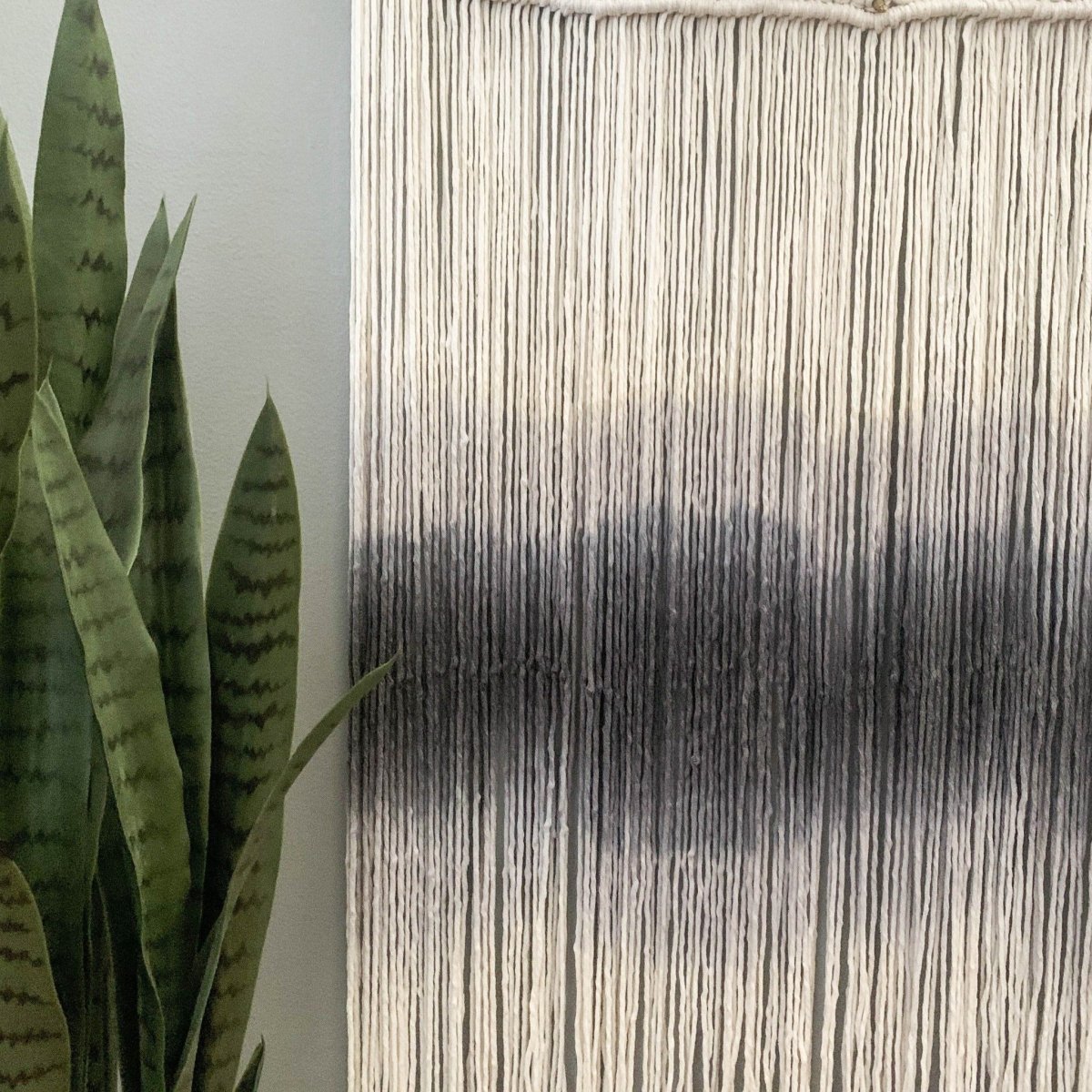 Handcrafted macrame tapestry close-up showing dip dye gradient and detail