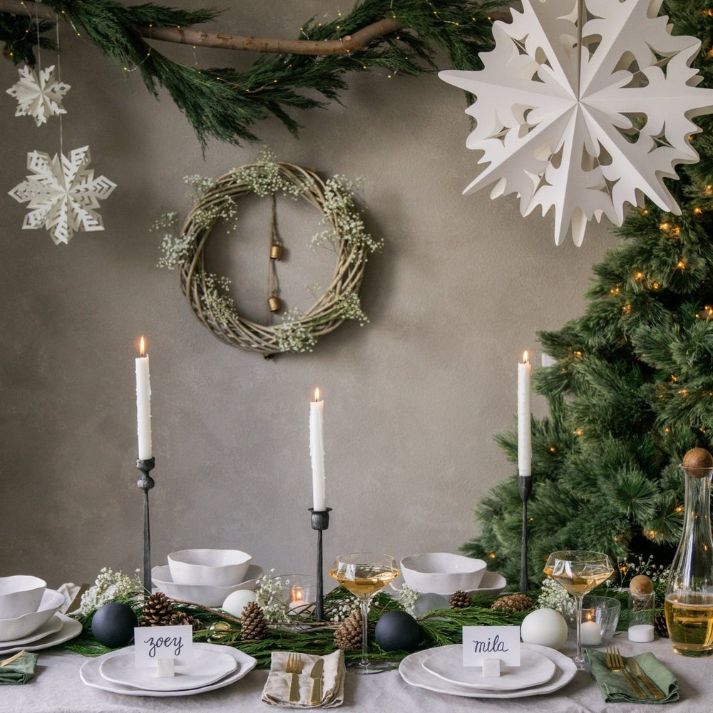 Flurry™ Hanging Paper Snowflakes styled above a Christmas tablescape