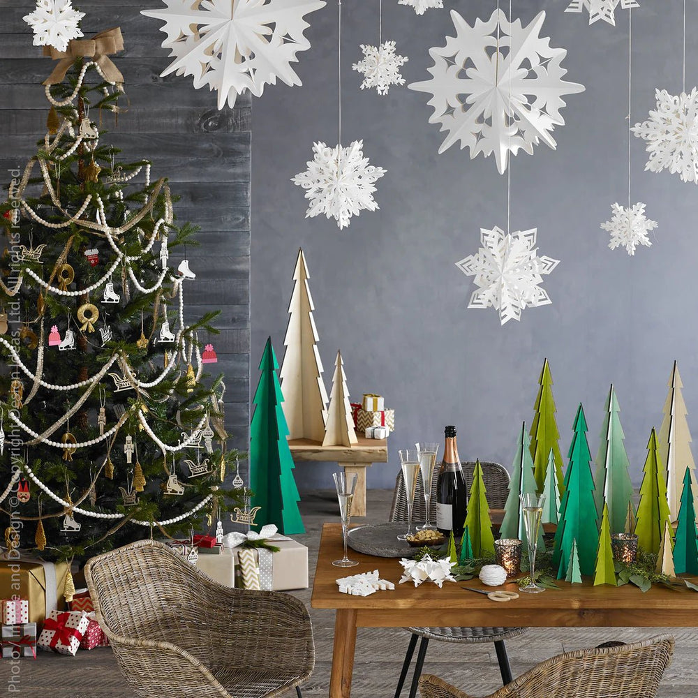 
                      
                        An assortment of Flurry™ Hanging Paper Snowflakes above a Christmas tablescape
                      
                    