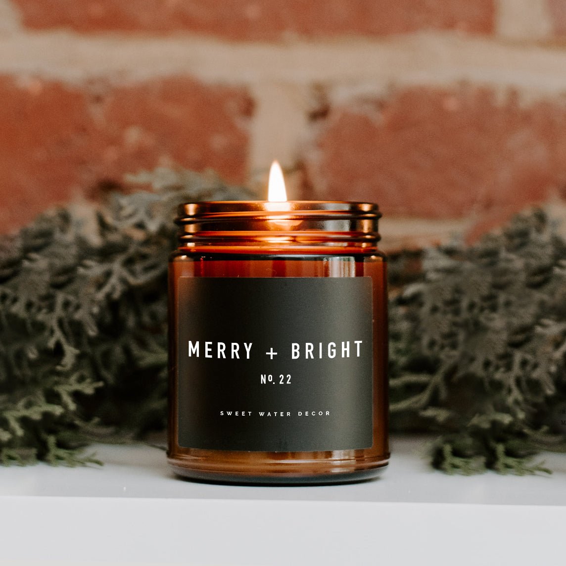 Sweet Water Decor Merry + Bright Soy Candle - Amber Jar - 9 oz - lily & onyx