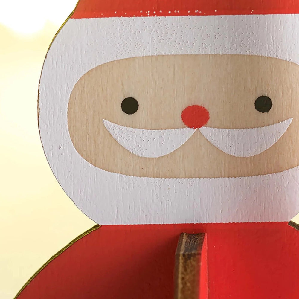 
                      
                        A closeup of a Nordic Santa™ Slotted Poplar Wood Ornament against a yellow background
                      
                    