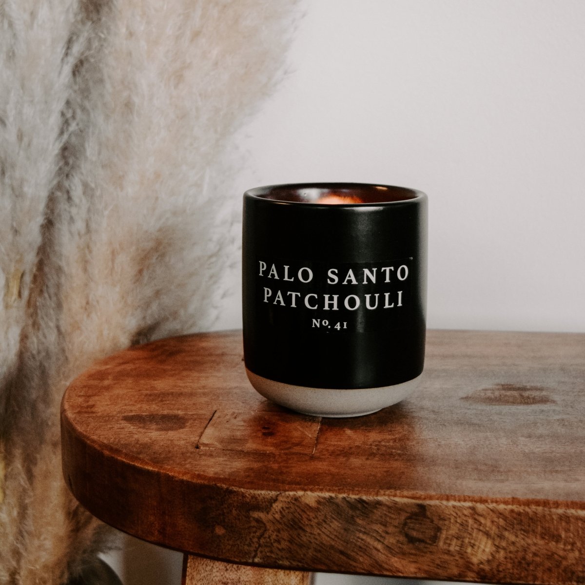 Sweet Water Decor Palo Santo Patchouli Soy Candle - Black Stoneware Jar - 12 oz - lily & onyx