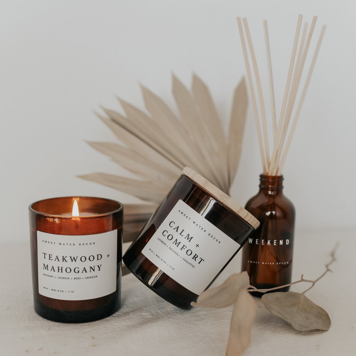 Sweet Water Decor Teakwood and Mahogany Soy Candle - Amber Jar - 11 oz - lily & onyx